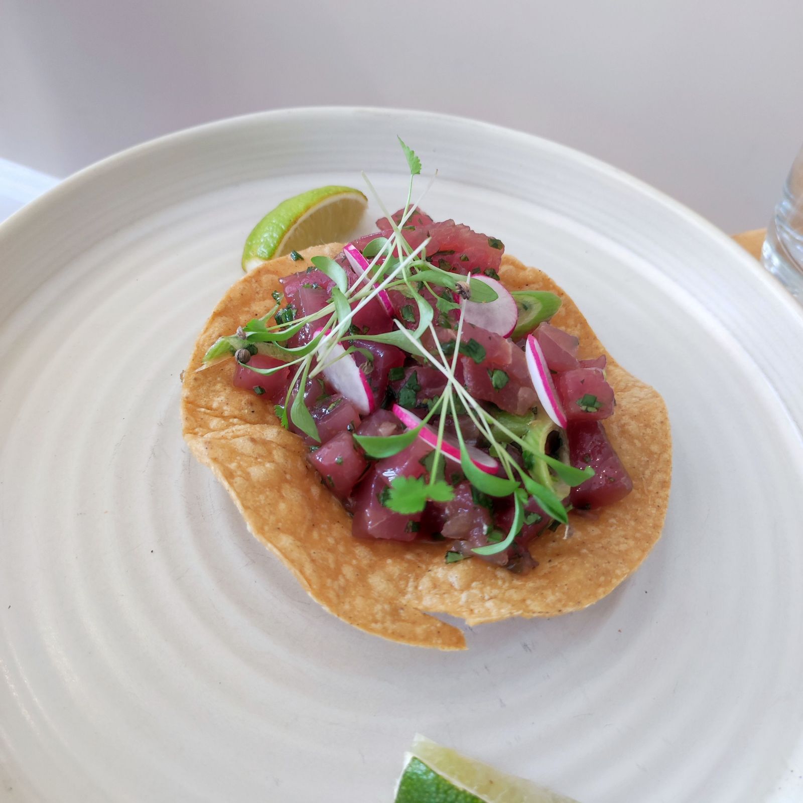 Ceviche of blue fin tuna tostada, sesame soy, lime, coriander, spring onion