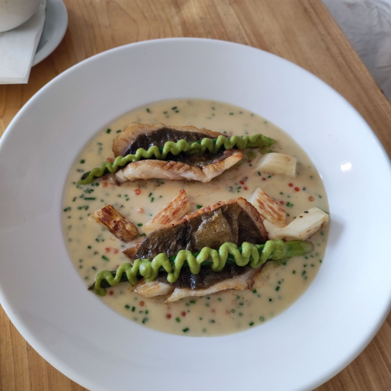Pan fried fillets of John dory, white asparagus, cronin's cider cream & root veg sauce, courgette pu